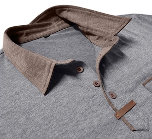 Close-up of contrast grey knit polo shirt with brown collar and button detail