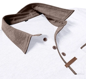 Macro detail of men's white polo shirt featuring a brown contrast collar and button placket