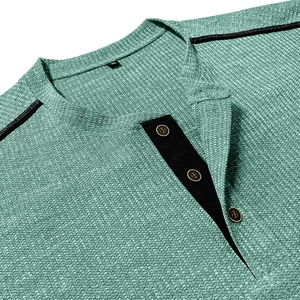 Detail of waffle knit fabric and contrast trim on men's mint green Henley shirt