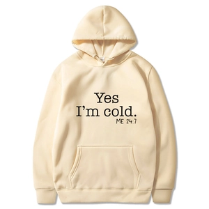 Detail of cream hoodie featuring black 'Yes I'm cold' print and kangaroo pocket