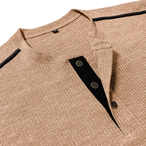 Detail of waffle knit fabric texture and three-button contrast placket on Henley shirt
