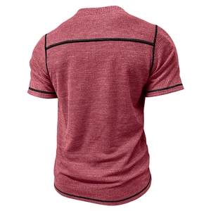 Detail view of burgundy waffle knit fabric with black contrast stitching on men's t-shirt