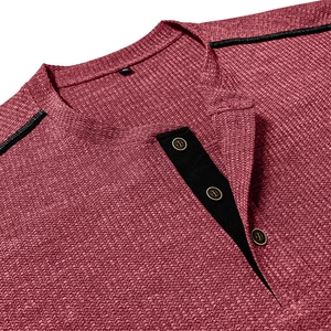 Detailed macro view of waffle knit fabric and button placket on a men's henley shirt