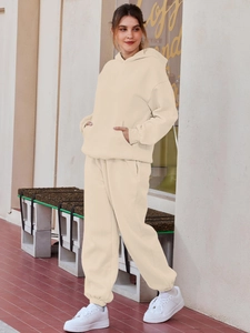 Detail of off-white hoodie set featuring a kangaroo pocket and ribbed cuffs for autumn style