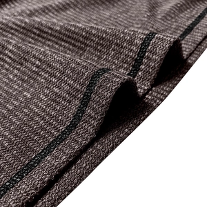 Close-up of waffle knit texture and black striped edge on men's Henley shirt fabric