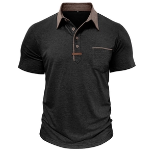 Close-up of charcoal grey polo shirt with brown contrast collar and chest pocket detail