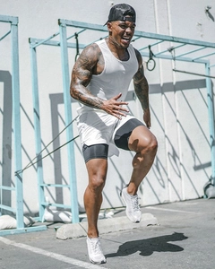 Dynamic view of men's white two-layer running shorts and tank top for intense training