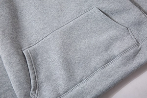 Detailed macro view of the grey hoodie kangaroo pocket with durable double-needle stitching
