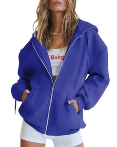 Detail of oversized dark blue zip-up hoodie featuring dropped shoulders and ribbed cuffs