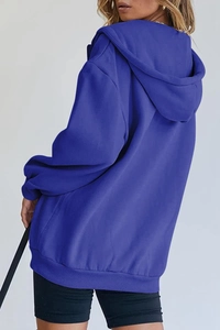 Detail of royal blue oversized hoodie featuring drop shoulders and ribbed hemline