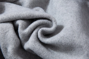 Macro detail of soft grey thick fleece lining on sweatshirt for warmth and texture