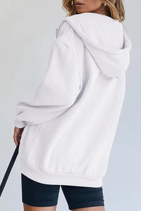 Detailed back view of oversized white hoodie featuring a spacious hood and ribbed cuffs