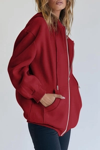 Detailed side view of an oversized dark red zip-up hoodie featuring a fleece texture