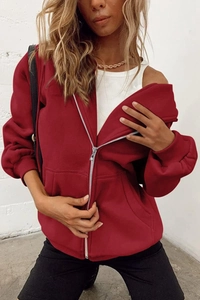 Detail of burgundy oversized zip-up hoodie featuring a silver zipper and ribbed cuffs
