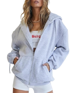 Detail of grey oversized zip-up hoodie featuring ribbed cuffs and side pocket texture