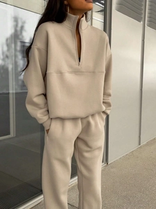 Detail of oatmeal two-piece fleece tracksuit with half-zip sweatshirt and straight pants