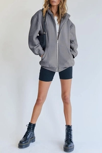 Oversized dark grey zip-up hoodie featuring dropped shoulders and front pockets for women