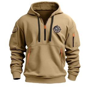 Detail of khaki tactical hoodie featuring half-zip collar and orange zipper pulls