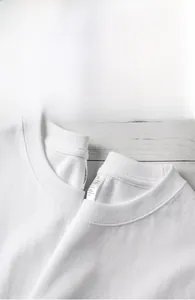 Detailed view of 100% pure combed cotton fabric and collar on a white casual t-shirt