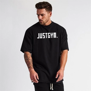 Detail of loose-fit black muscle gym t-shirt with white JUSTGYM print on the chest