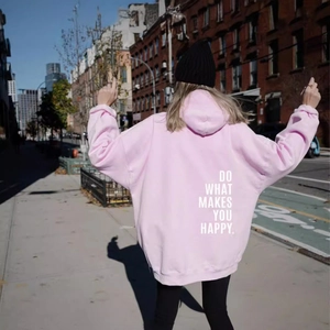 Pink oversized hoodie with 'Do What Makes You Happy' back print on urban street background