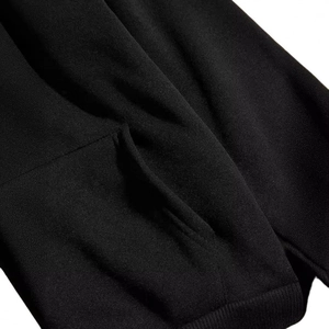 Close-up of black hooded sweatshirt with ribbed hem and side pocket detail
