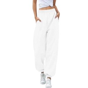 Detail of high waisted white jogger sweatpants with elastic waistband and side pockets