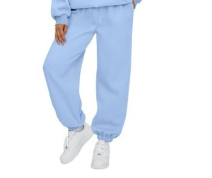Detail view of light blue high-waisted jogger pants with elastic cuffs and soft fabric
