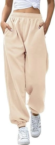 Detail of high waisted beige joggers featuring elastic waistband and functional side pockets