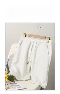Detail of light grey cotton knit sweat shorts with drawstring elastic waistband