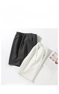 Flat lay of gray and light gray drawstring casual shorts with breathable texture detail