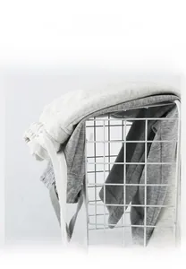Close-up of soft cotton knit lounge shorts with drawstring waist in a metal basket