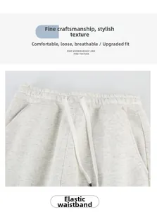 Detail of light grey cotton sweat shorts featuring an adjustable elastic drawstring waistband
