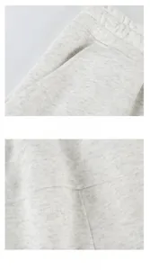 Detail view of grey cotton sports shorts with elastic waistband and large side pocket