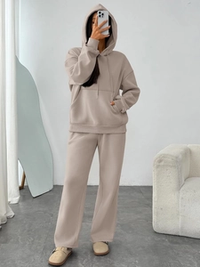 Detail of warm apricot oversized hoodie and wide-leg jogger pants for women