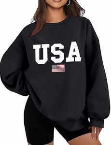 Close-up of black oversized sweatshirt featuring bold USA text and American flag print