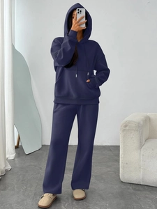 Detail view of navy blue oversized hooded sweatshirt and wide-leg joggers lounge set