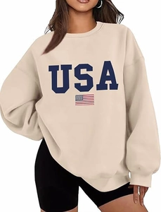 Close-up of USA letter print and flag detail on oversized beige crewneck sweatshirt