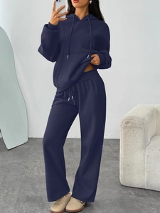 Detail of navy blue oversized hoodie with kangaroo pocket and loose wide-leg sweatpants