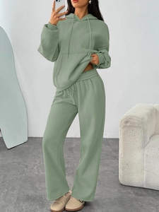 Detail of sage green oversized hoodie and wide-leg sweatpants in high-quality knit fabric