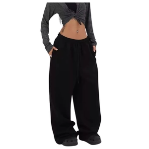 Close-up of black wide-leg sweatpants with drawstring waist and soft cotton texture