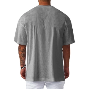 Close-up of the grey breathable mesh fabric texture on the back of a men's gym t-shirt