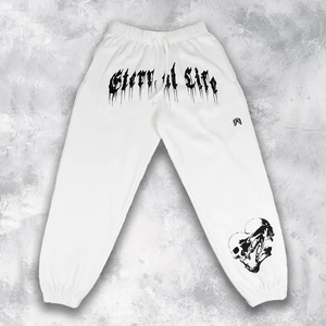 Detail of white sweatpants with Gothic Eternal Life lettering and skull heart print