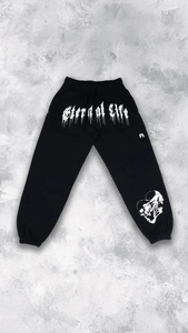 Detail of black jogger sweatpants with white Eternal Life gothic lettering and skull print
