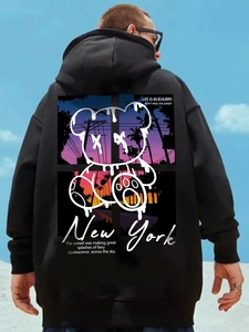 Detailed back view of oversized black hoodie with melting bear and palm tree print