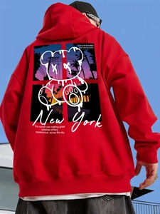 Detail of red oversized hoodie featuring doll graphic and text on back in street style