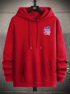Detail of red oversized hoodie featuring colorful graffiti bear print and kangaroo pocket