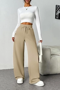 Detail of high waist khaki wide leg trousers with adjustable drawstring and soft knit fabric