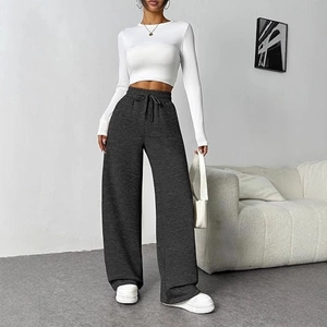 Women's casual outfit with white crop top and dark grey high waist wide leg trousers