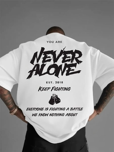 Oversized white cotton T-shirt featuring gothic NEVER ALONE graphic print on back